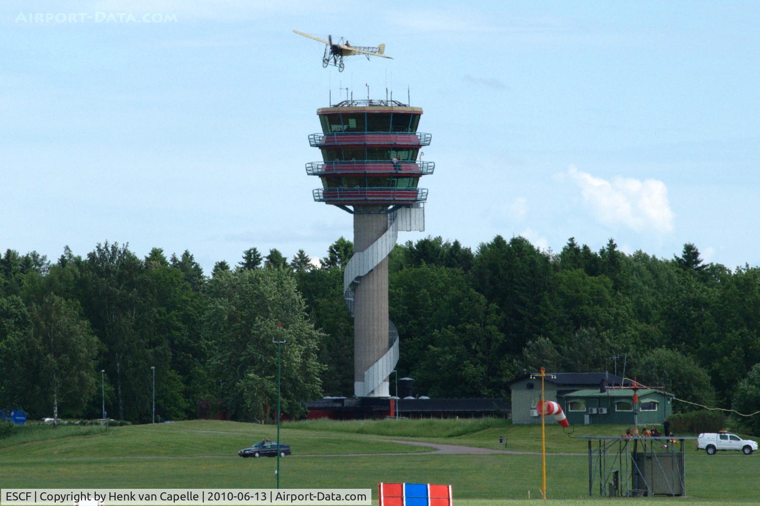 Malmen Air Base Airport, Linköping Sweden (ESCF) - The tower of Malmen Air Base with the Thulin A (Bleriot XI) of Mikael Carlson flying above it during the 2010 Open Day.