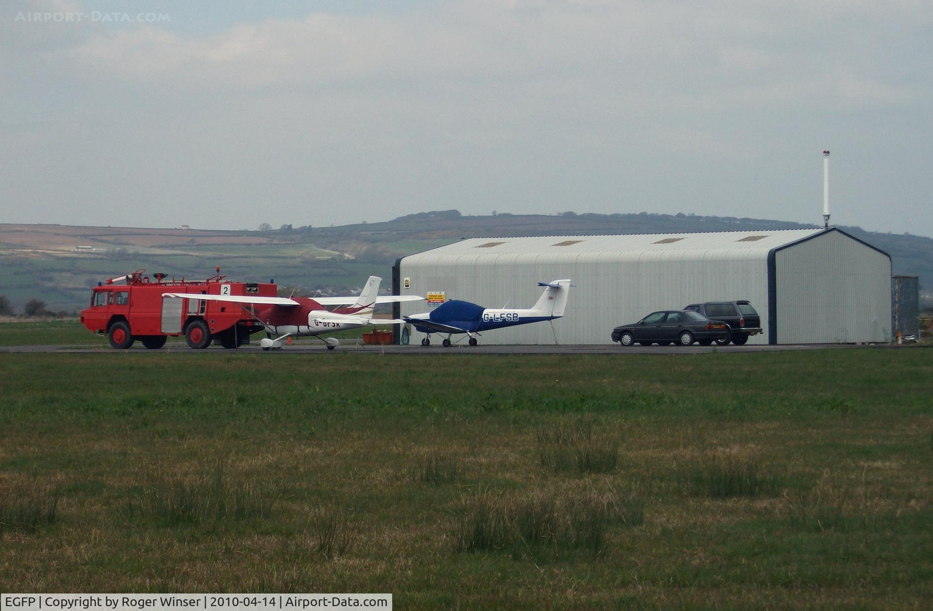 Pembrey Airport, Pembrey, Wales United Kingdom (EGFP) - Pembrey Airport hangar, resident aircraft and Fire and Rescue tender FIRE 2. 