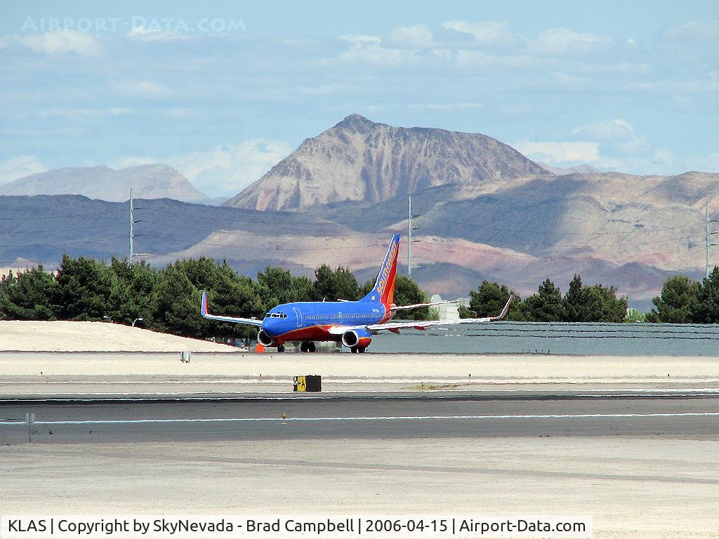 Harry Reid International Airport (LAS) - Southwest Airlines / Shimmering in the afternoon heat ready for take-off on RWY 25R. The mountain in the background is a Volcano.
