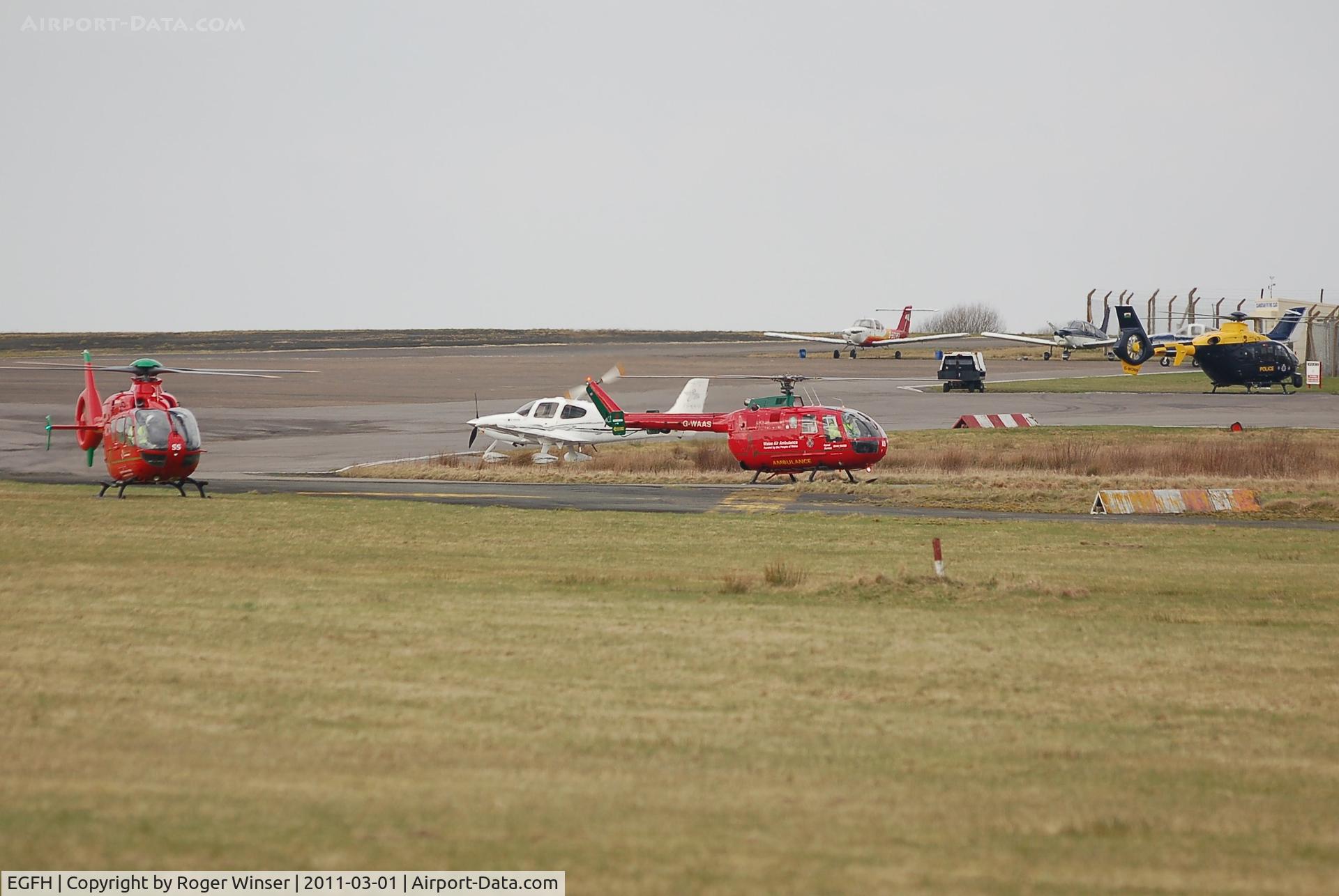 Swansea Airport, Swansea, Wales United Kingdom (EGFH) - North and Mid-Wales Air Ambulance helicopters and the South and East Wales Police Air Support Unit helicopter about to depart and join up with the South Wales Air Ambulance helicopter to celebrate the 10th anniversary of Wales Air Ambulance held in Margam