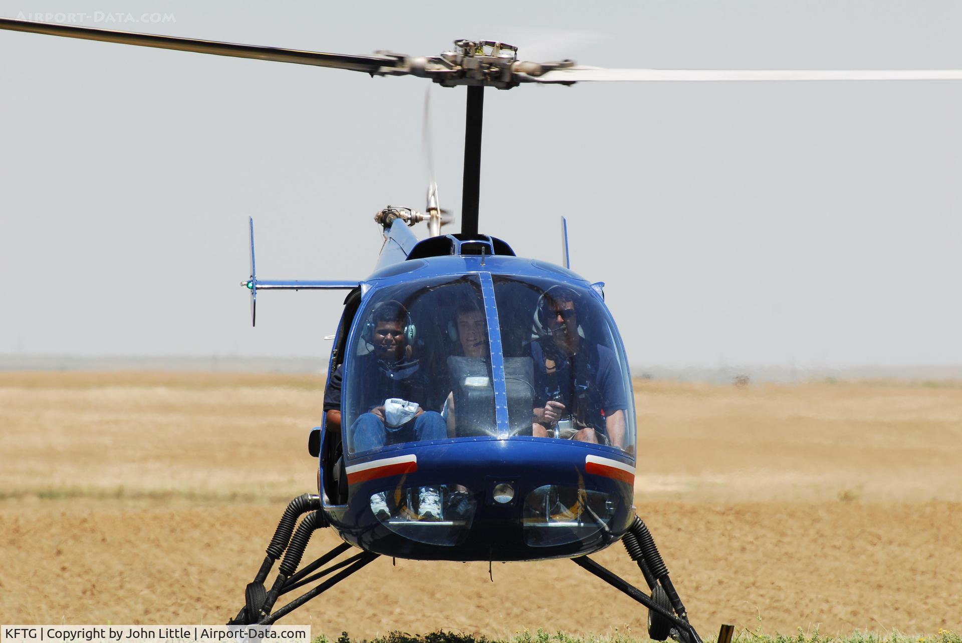 Front Range Airport (FTG) - My son (center seat) taking chopper ride at EAA Fly In