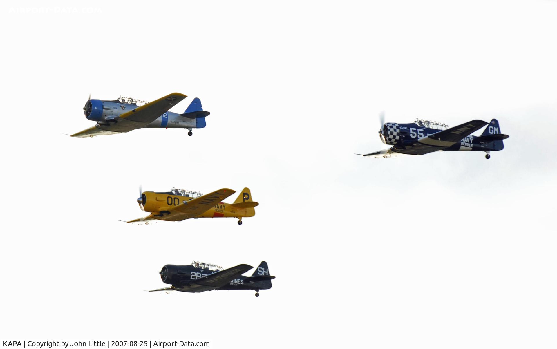 Centennial Airport (APA) - SNJ and T6 formation overflight , John Z. leads followed by Jack C., Gary M., and Julie S.  - great formation group. Overexposed since photo was shot so late in evening towards the sun