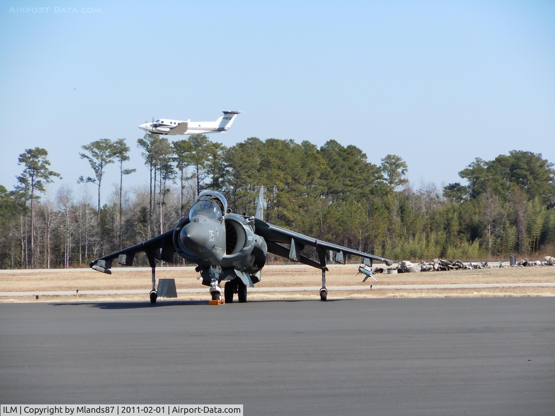Wilmington International Airport (ILM) - A Marine Harrier sits on the tarmac of ILM waiting to be refuled as normal air traffic continues around it.