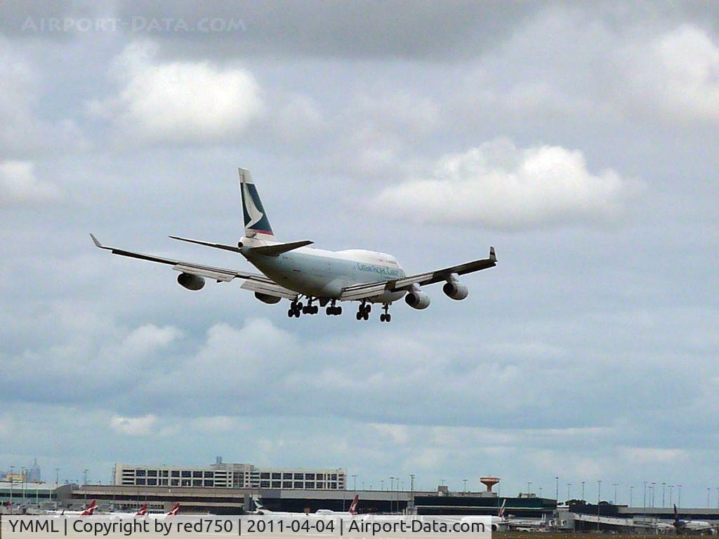 Melbourne International Airport, Tullamarine, Victoria Australia (YMML) - Cathay Pacific Cargo Boeing 747 B-HOU arriving runway 16 at Melbourne, over the International Terminal. The multi storey building is the airport hotel above the multi level short term car park. Qantas domestic terminal is on the left.