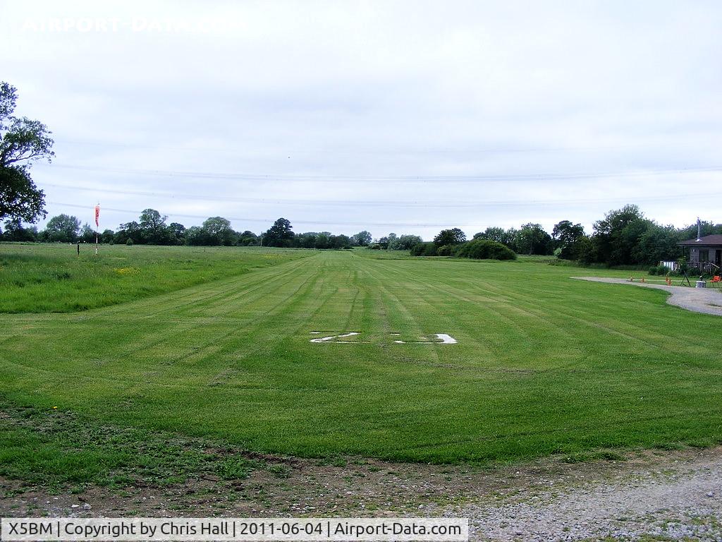 X5BM Airport - view down RW23 at Baxby Manor, note the High voltage transmission lines that pass over the runway