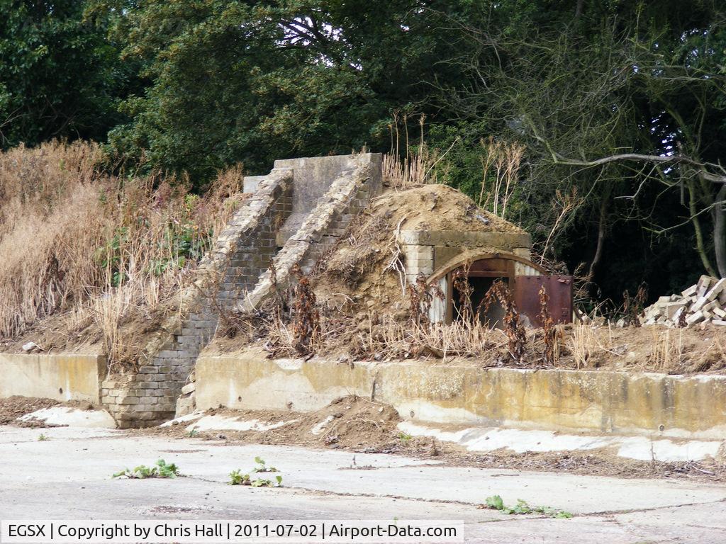North Weald Airfield Airport, North Weald, England United Kingdom (EGSX) - WWII air raid shelter at the rear of one of the E pens at North Weald Airfield