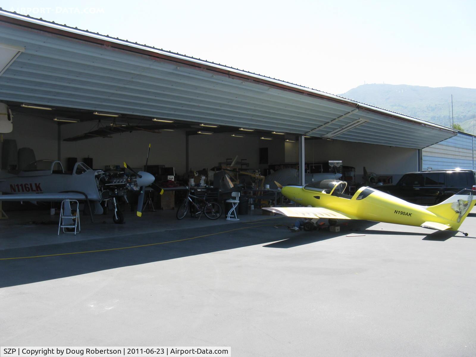 Santa Paula Airport (SZP) - Aviation F/X, Assorted Experimental aircraft. In build hangar. Pulsar on apron. Just a visible bit of a Turbine Legend fuselage hanging from ceiling storage-upper left. 