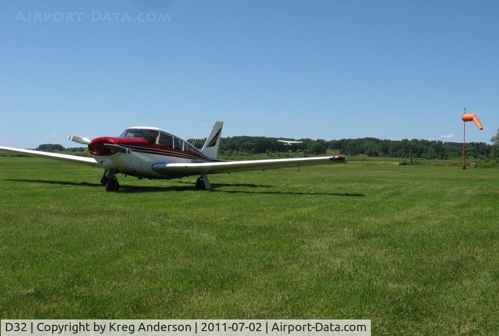 Starbuck Municipal Airport (D32) - A view of a Piper Commanche and the windsock at Starbuck Airport with a Cessna Skyhawk taking off in the background.