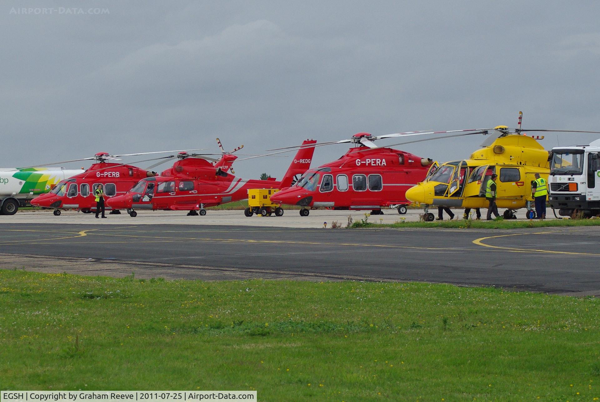 Norwich International Airport, Norwich, England United Kingdom (EGSH) - A line up of Bond and NHL helicopters.