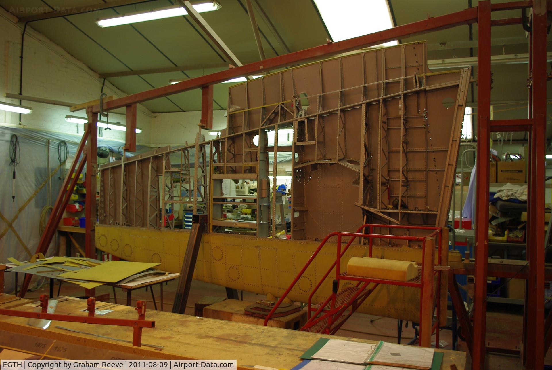 EGTH Airport - Spitfire wing under restoration at the Shuttleworth collection.