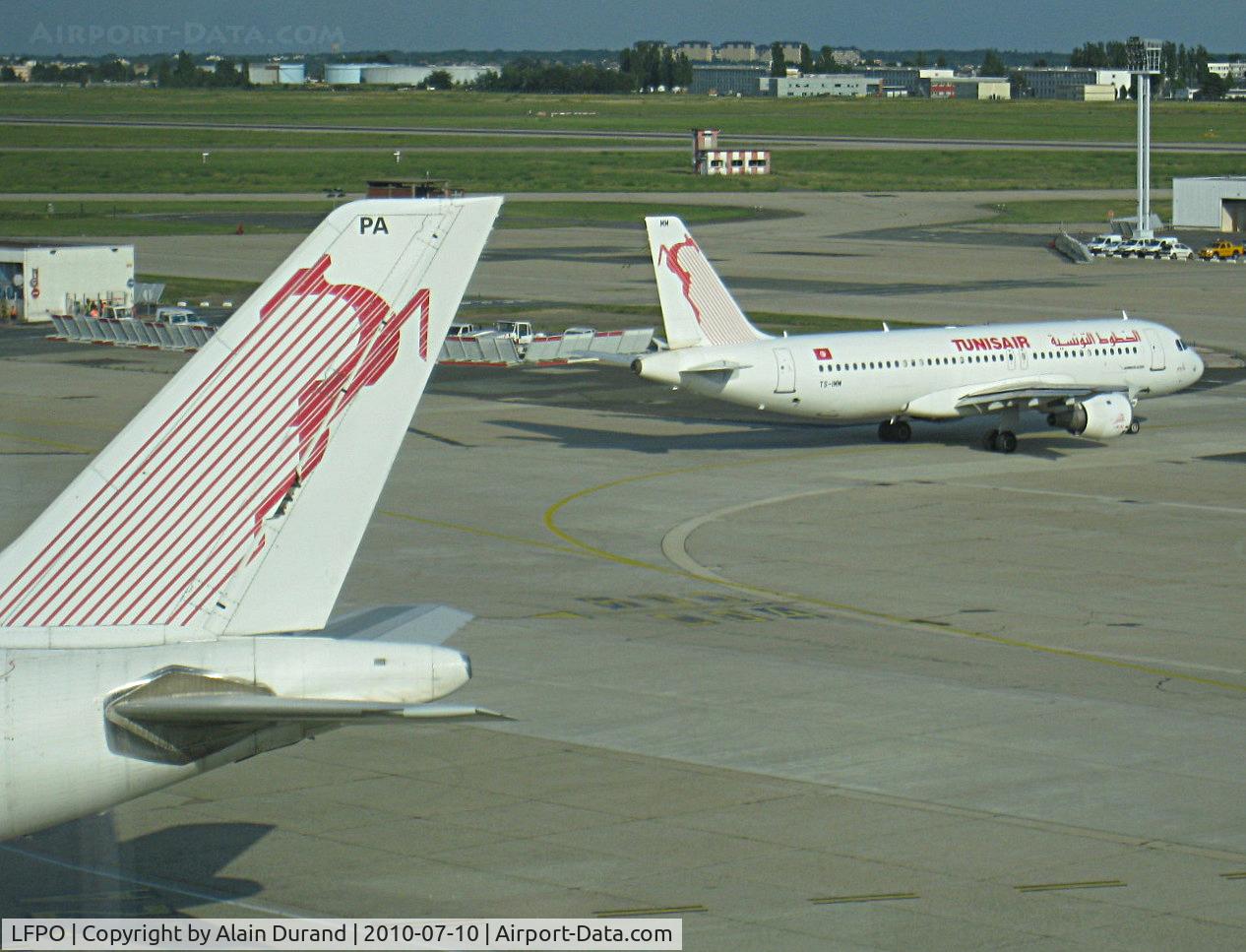 Paris Orly Airport, Orly (near Paris) France (LFPO) - The tail belongs to TS-IPA, one of the four A300-600s in service with Tunisair. Departing A320-211 TS-IMM was heading to runway 08/26