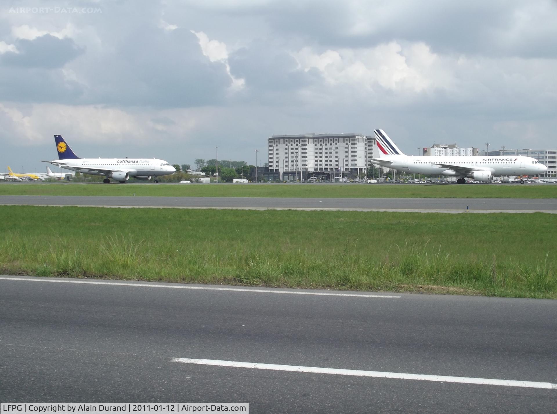 Paris Charles de Gaulle Airport (Roissy Airport), Paris France (LFPG) - AF A320 F-HEPB was taxying to Terminal 2 after landing on runway 09L, acting as a chaser, Lufthansa Italia's MicroBus had departed Terminal 1 and was heading to runway 08L