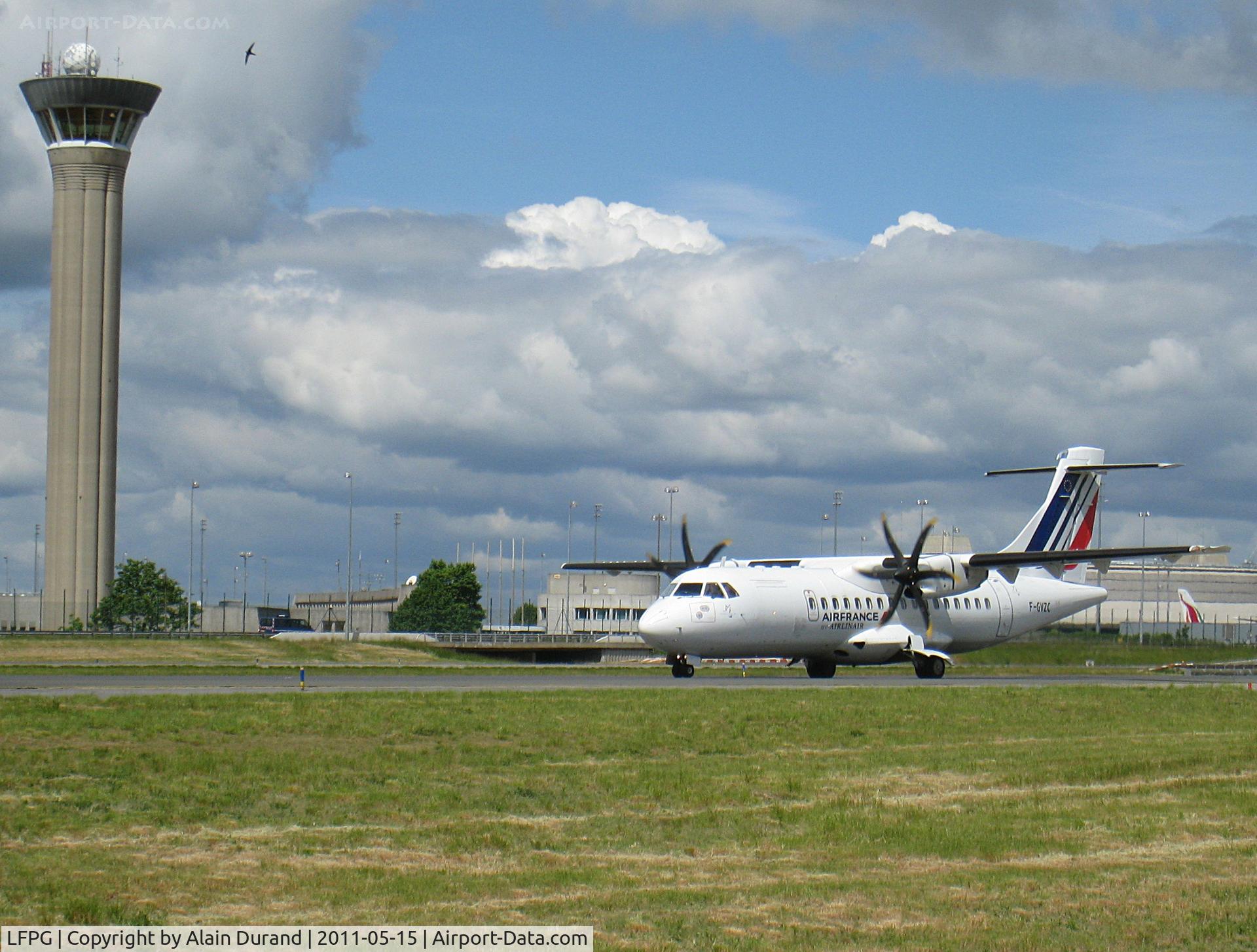 Paris Charles de Gaulle Airport (Roissy Airport), Paris France (LFPG) - Not anymore in use at daylight, the original control tower still stands by the parallels and dwarfs everything taxying around