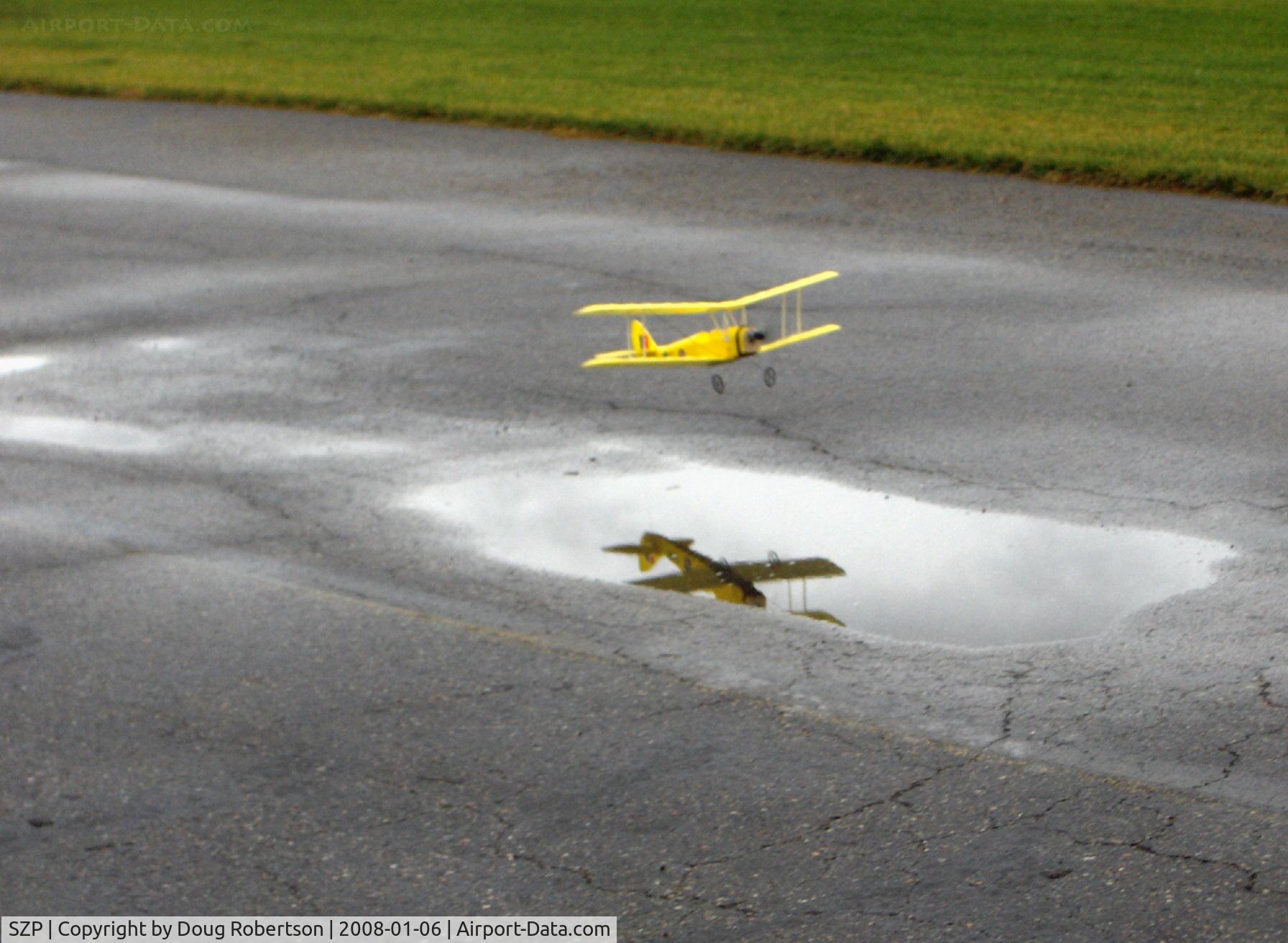 Santa Paula Airport (SZP) - Rick's Tiger Moth RC drone puddle jumper, reflected in flight
