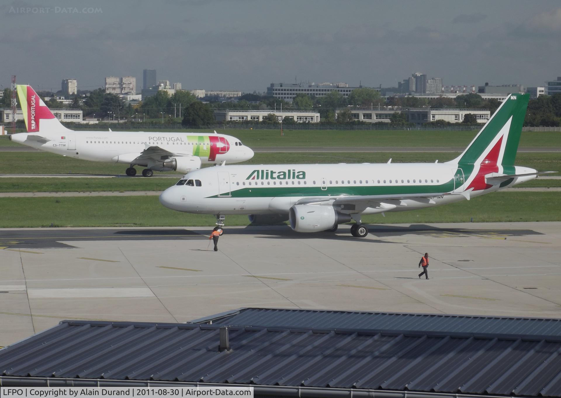 Paris Orly Airport, Orly (near Paris) France (LFPO) - While TAP A319 CS-TTM was taxying to runway 24 with LIS as the destination, AZ EI-IMN was seconds to depart the gate area