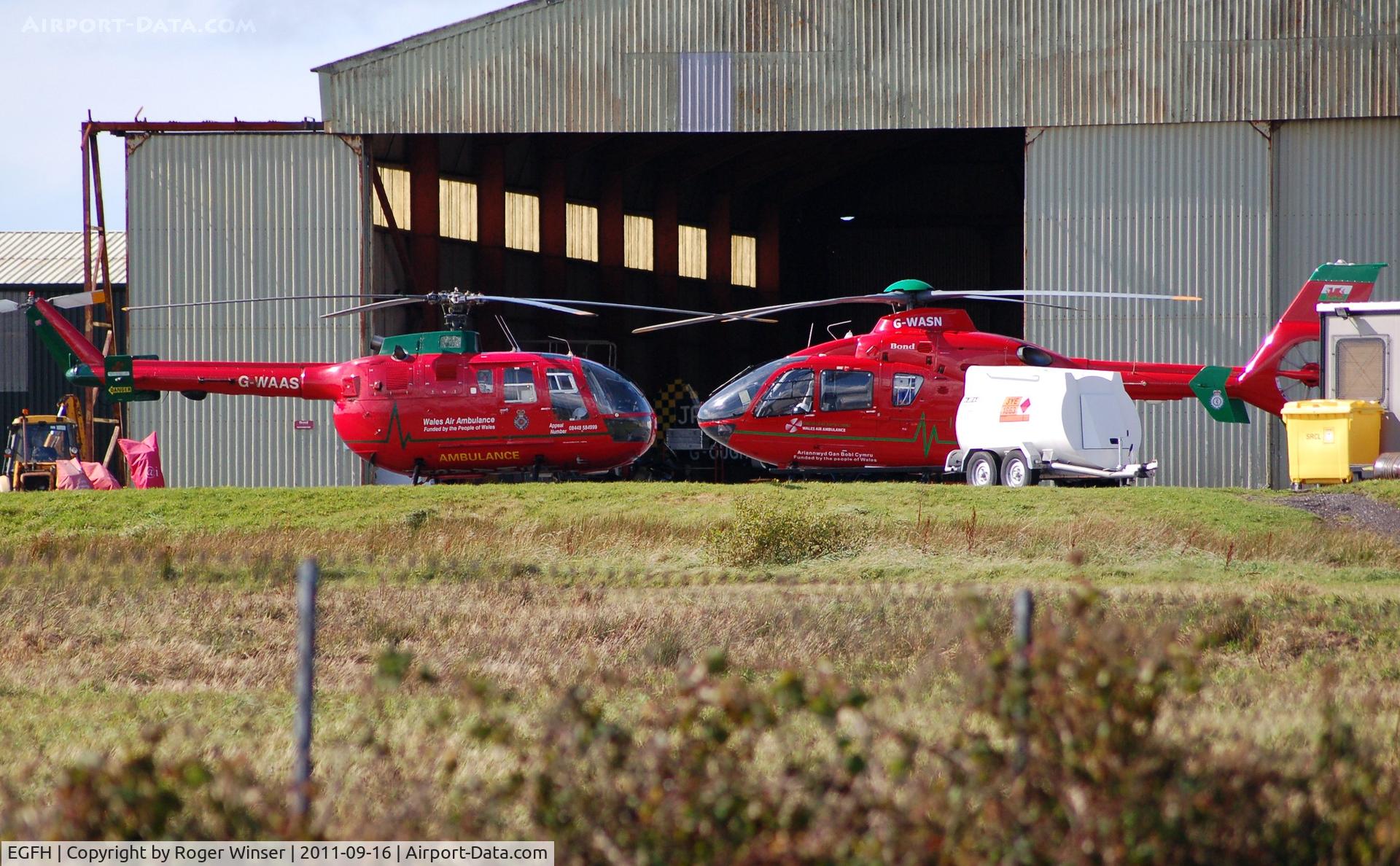 Swansea Airport, Swansea, Wales United Kingdom (EGFH) - Nose to nose. Visiting and resident Wales Air Ambulance helicopters