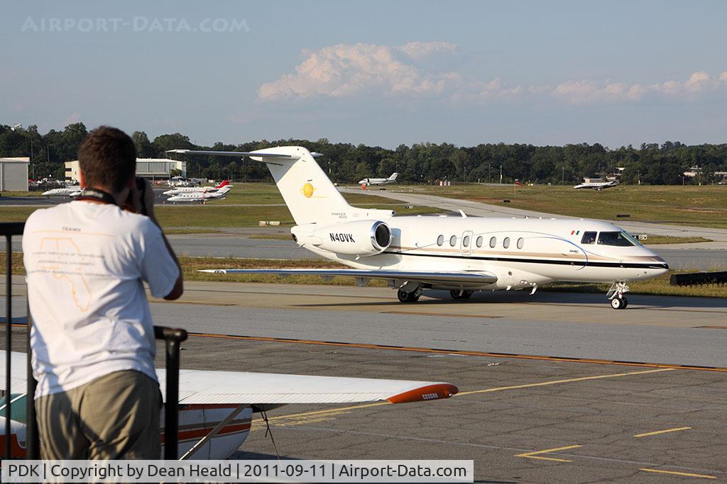 Dekalb-peachtree Airport (PDK) - From the spotting location at PDK, a person photographs a nice Hawker 4000, N40VK as it taxis by for departure.