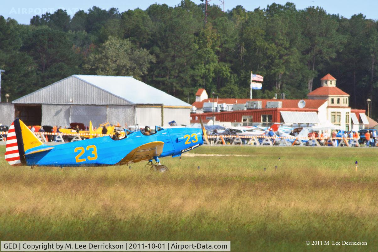 Sussex County Airport (GED) - Sussex County Airport Terminal in background as Fairchild M-62 taxis before take-off.