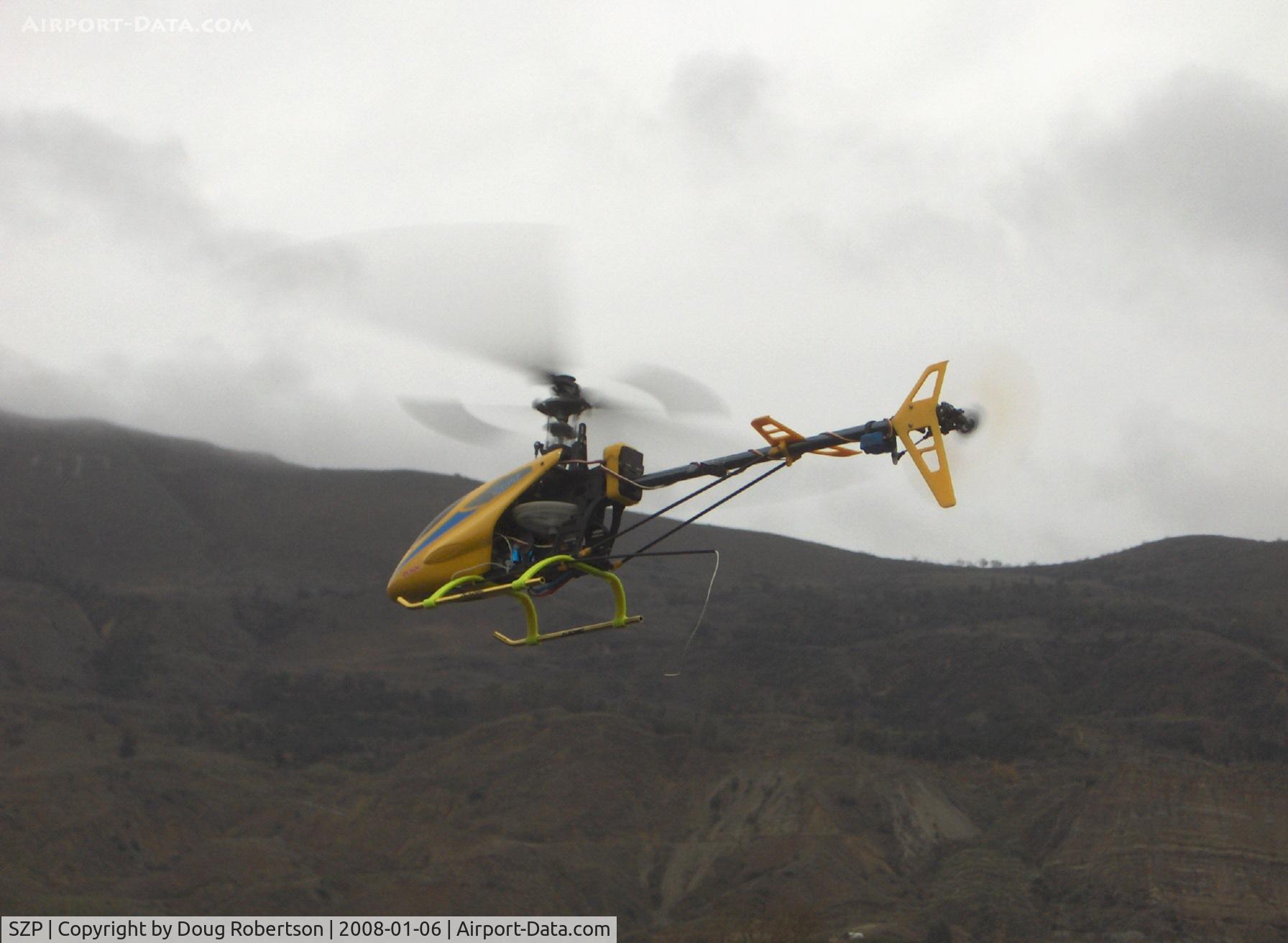 Santa Paula Airport (SZP) - Rick's RC drone T-REX helicopter, maneuvering, note trailing antenna