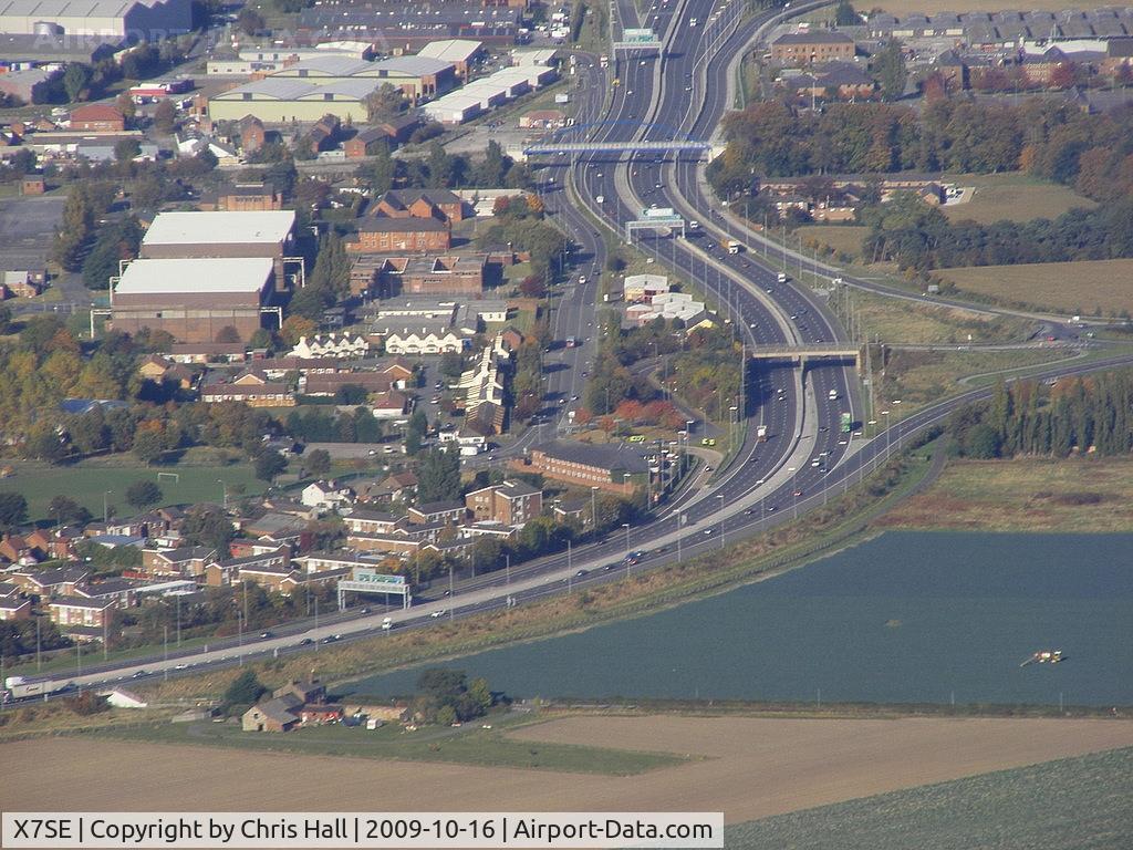 X7SE Airport - The old hangars at the former RAF Sealand site can be seen on the left of the main road