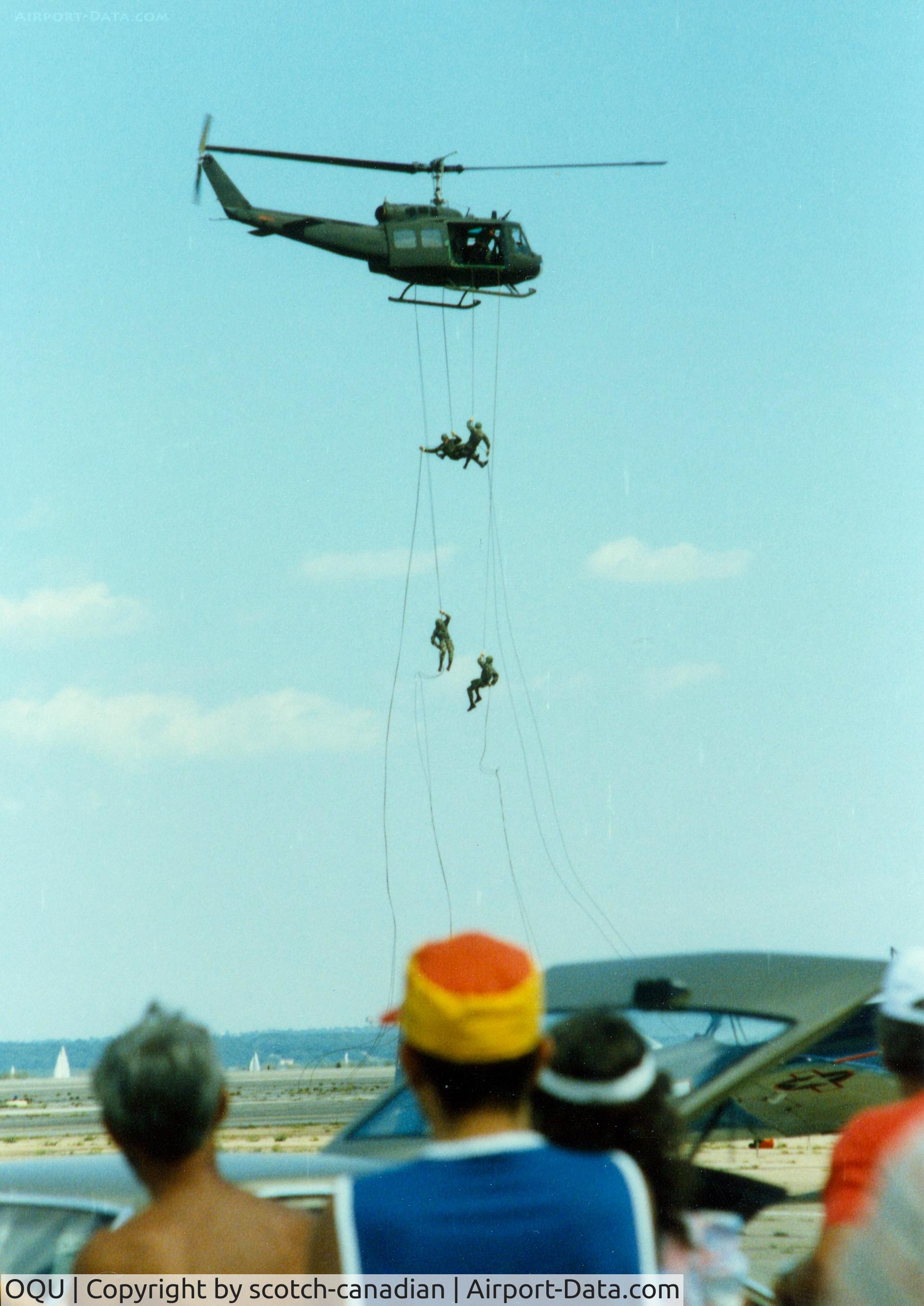 Quonset State Airport (OQU) - Rhode Island National Guard Soldiers rappelling from a Bell UH-1 Iroquois Helicopter at Quonset State Airport, North Kingstown, RI - circa 1980's
