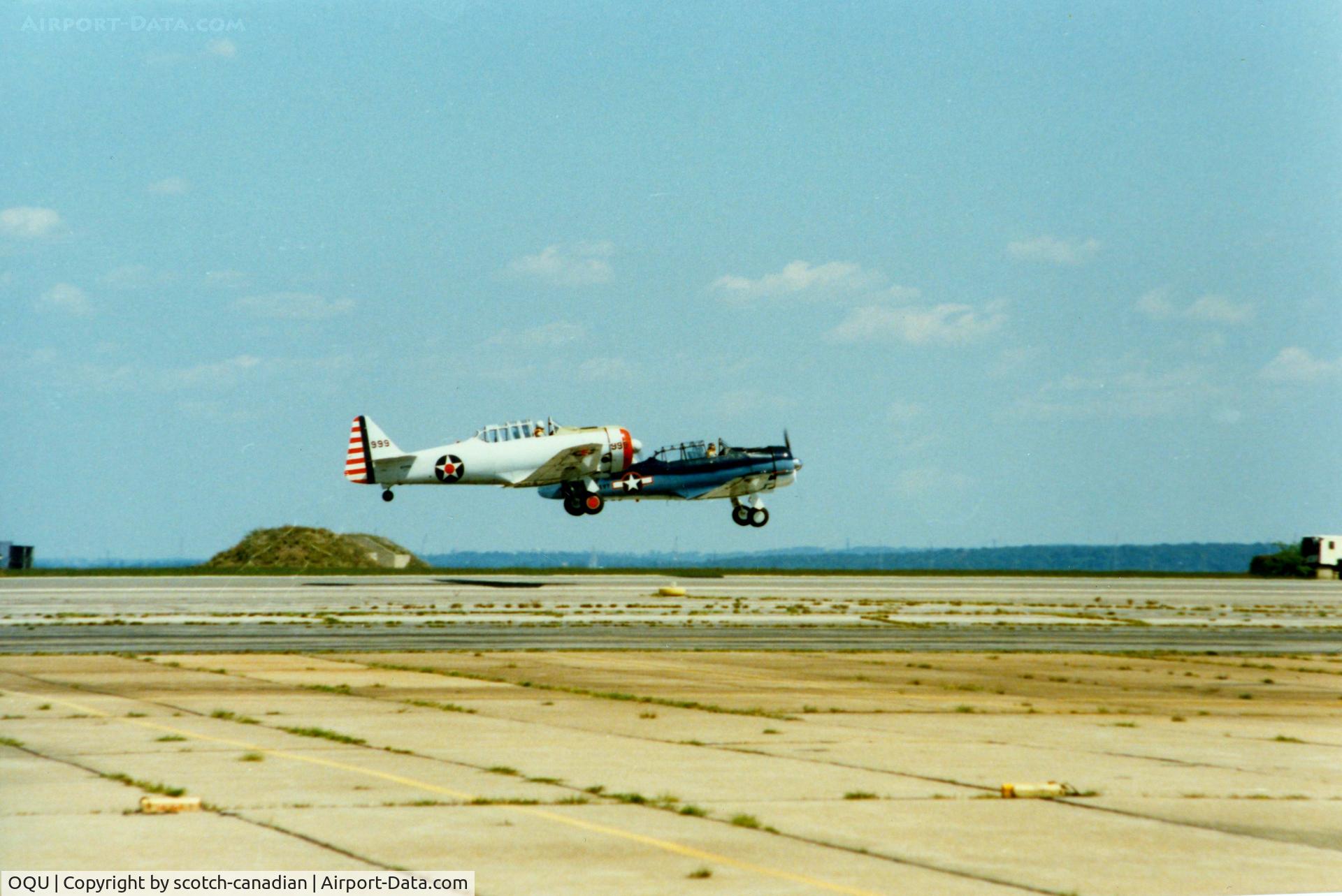 Quonset State Airport (OQU) - North American AT-6 Texan N44999 and 1958 North American SNJ-5 N3687F at Quonset State Airport, North Kingstown, RI - circa 1980's