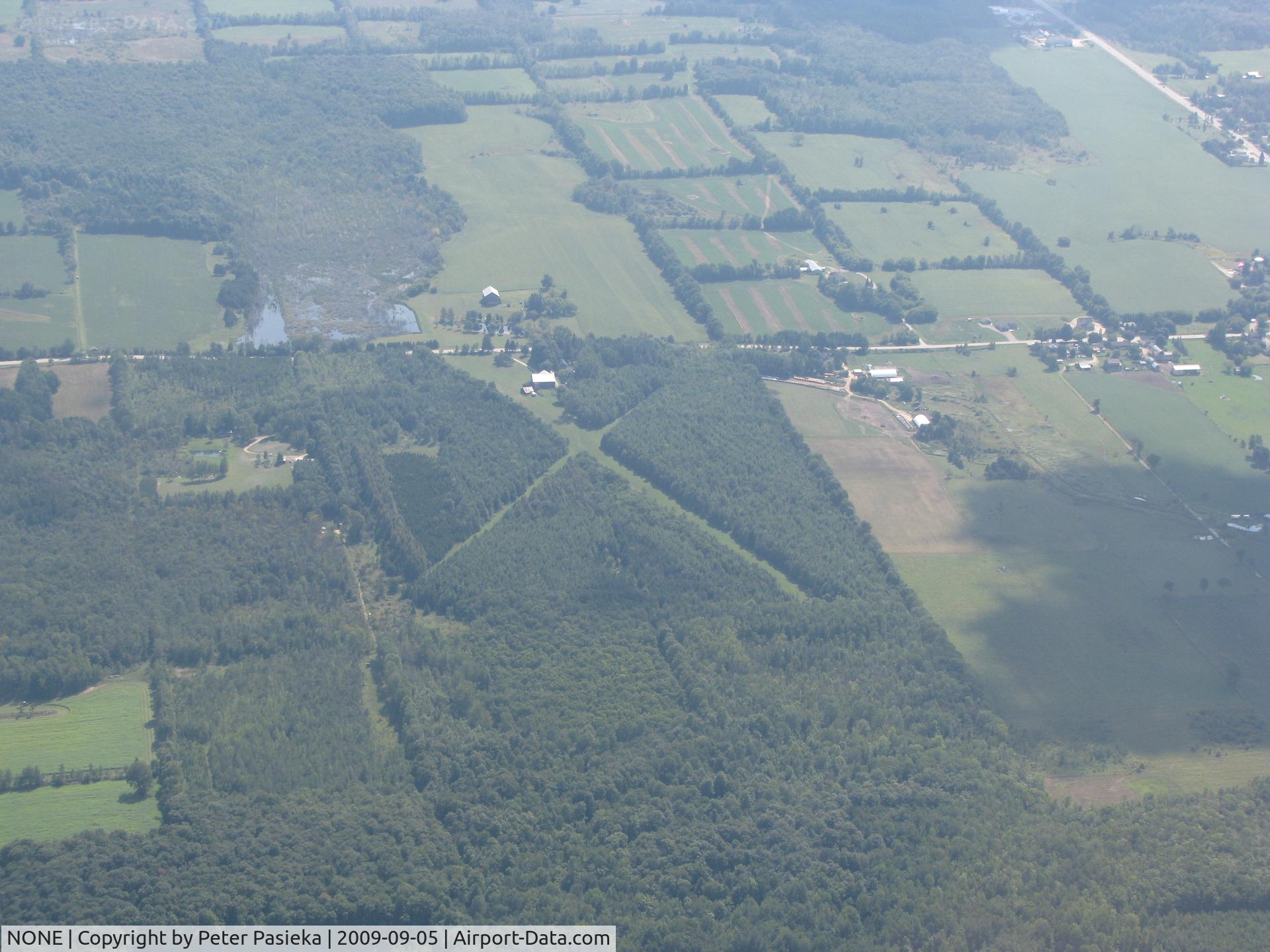 NONE Airport - Looks like someone gave up on the cross runway as it's too narrow, but the one looks good except for the trees on both sides.