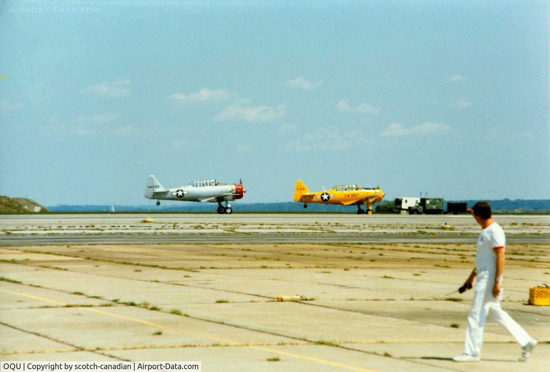 Quonset State Airport (OQU) - North America AT-6 Texan N6984C and North American AT-6 Texan 51-14987 at Quonset State Airport, North Kingstown, RI - circa 1980's