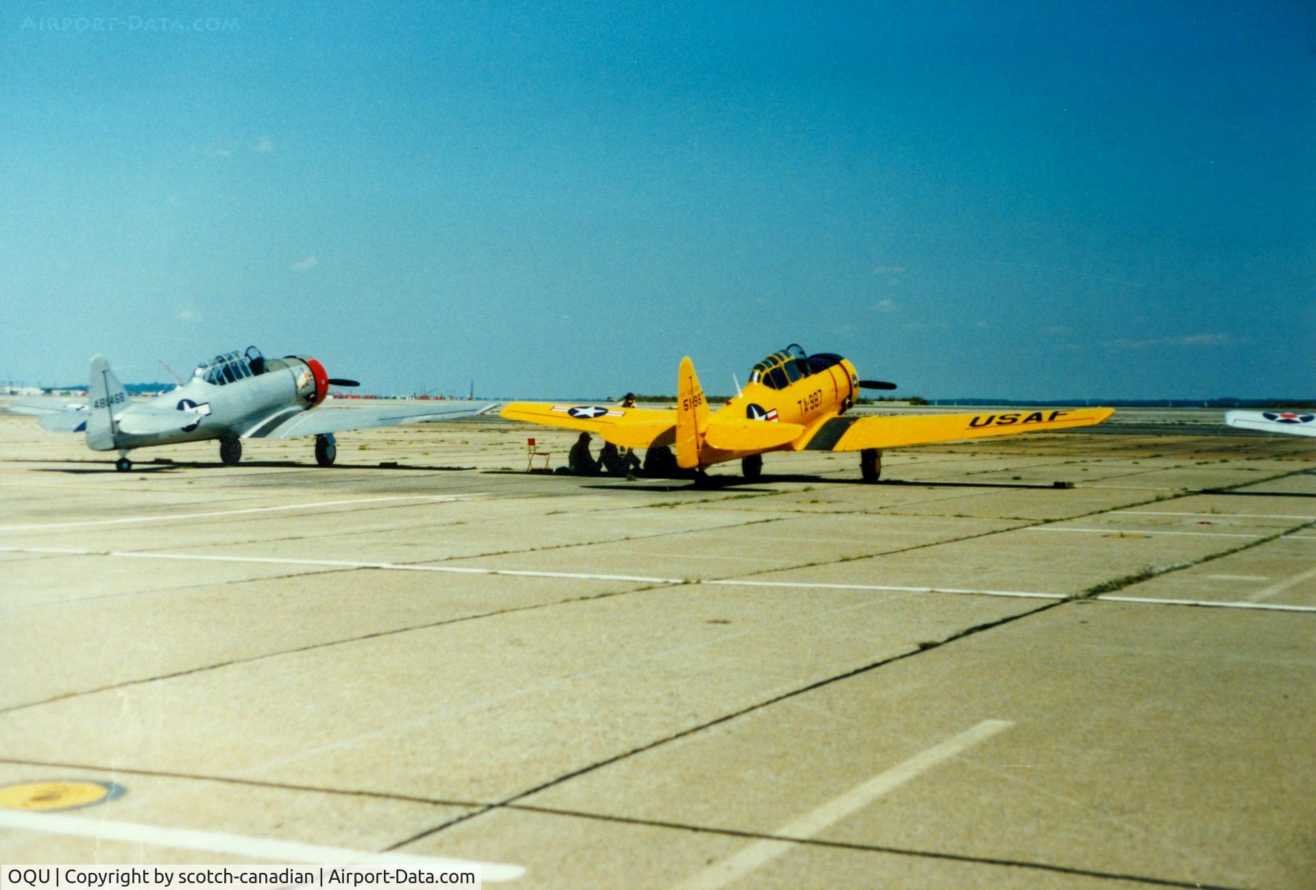 Quonset State Airport (OQU) - North America AT-6 Texan N6984C and North American AT-6 Texan 51-14987 at Quonset State Airport, North Kingstown, RI - circa 1980's