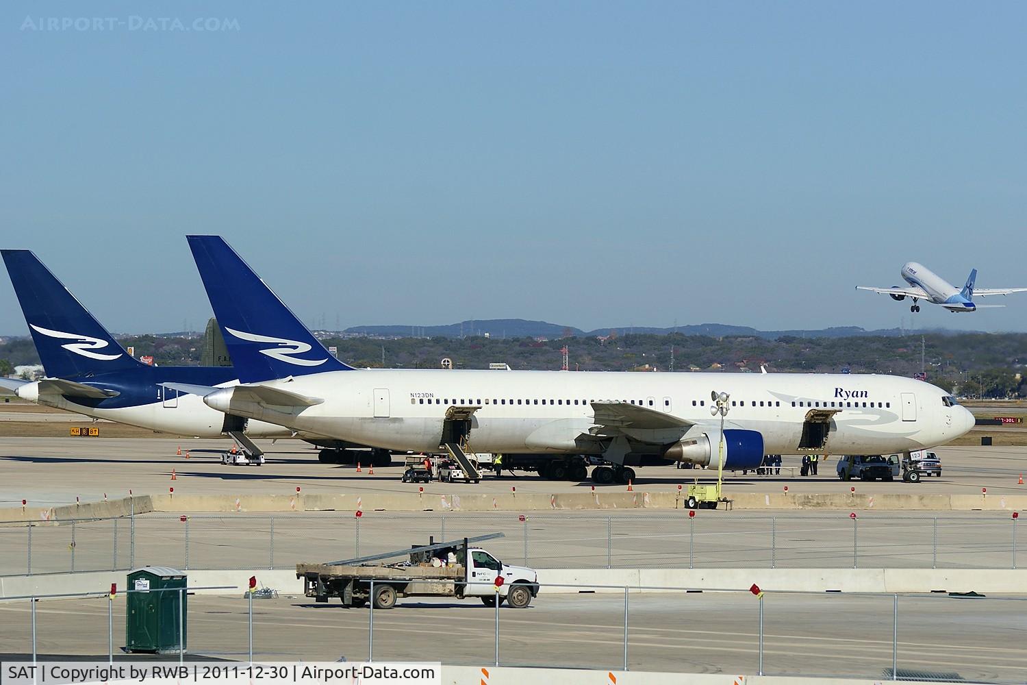 San Antonio International Airport (SAT) - N123DN (foreground) & N125RD parked at west cargo area waiting on the University of Washington football team and others headed back after the Alamobowl previous night