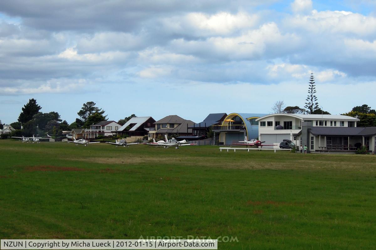 Pauanui Beach Aerodrome Airport, Pauanui New Zealand (NZUN) - Houses with hangar downstairs, looking onto the runway! How beautiful is that?