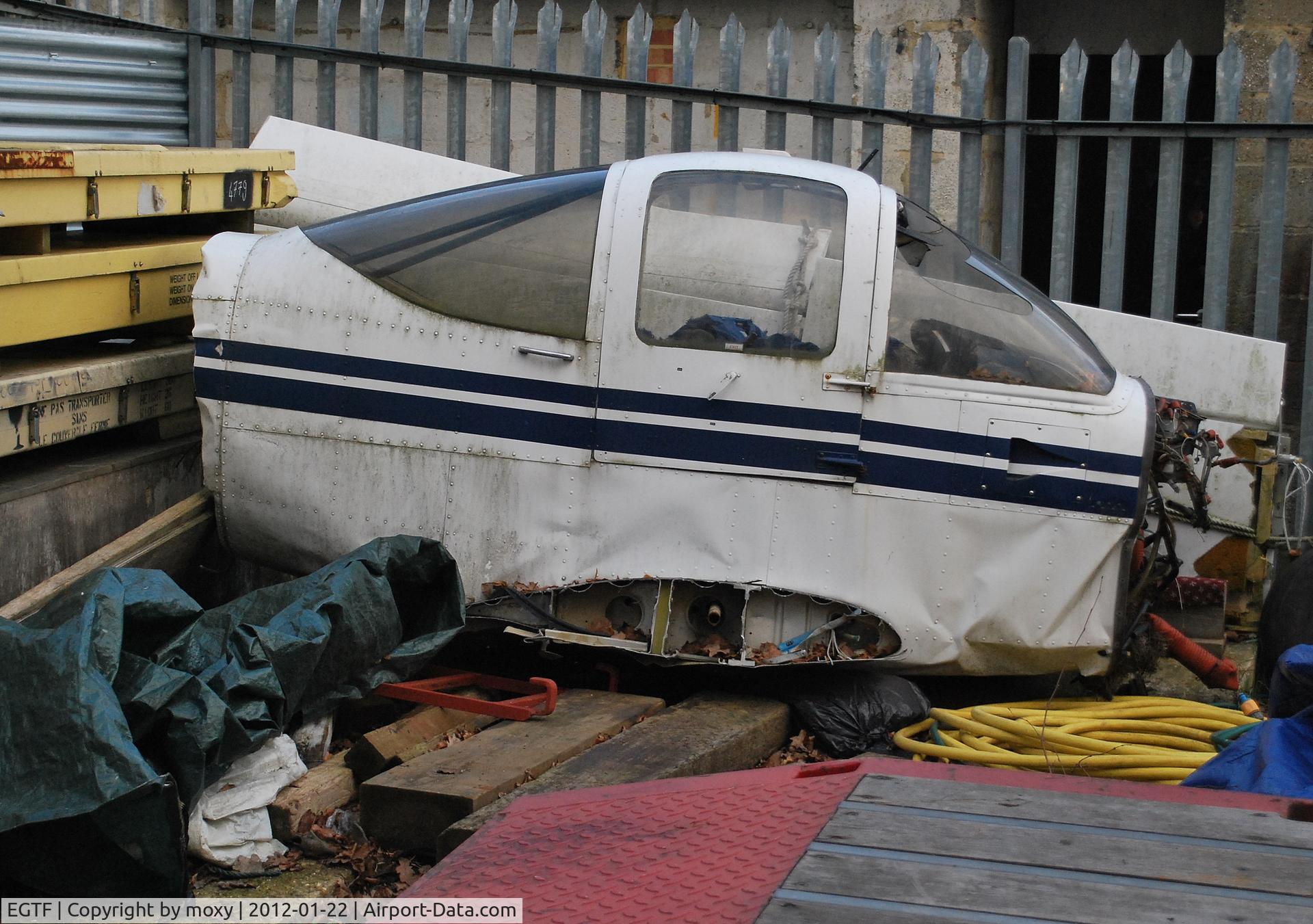 Fairoaks Airport, Chobham, England United Kingdom (EGTF) - Unidentified PA-38 Tomahawk section in the compound at Fairoaks. The wings behind are from Cirrus SR22 G-TAAA which crashed at Denham.