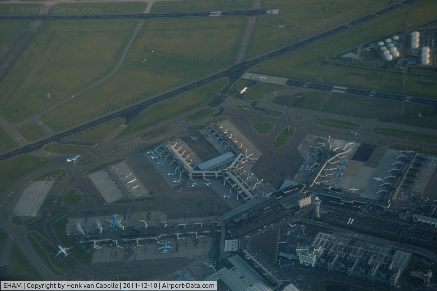 Amsterdam Schiphol Airport, Haarlemmermeer, near Amsterdam Netherlands (EHAM) - Amsterdam airport, Schiphol, seen from a KLM 777-300 while overflying. Lots of KLM aircraft and the tower are to be seen.