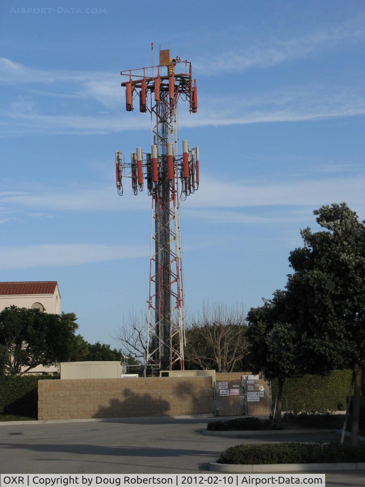 Oxnard Airport (OXR) - OXR's Airport Rotating Beacon (clear-green) with sector block to the OXR Air Traffic Control Tower, atop one of several antenna farms. Location: SE. White-red vertical antennas are cell phone repeaters.