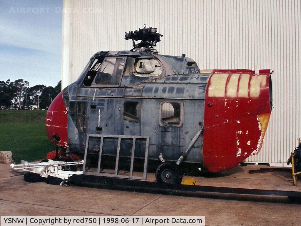 HMAS Albatross Airport, Nowra, New South Wales Australia (YSNW) - Photograph by Edwin van Opstal with permission. Scanned from a color print. Carcass of a Westland S-55 Whirlwind at HMAS Albatross, Nowra.