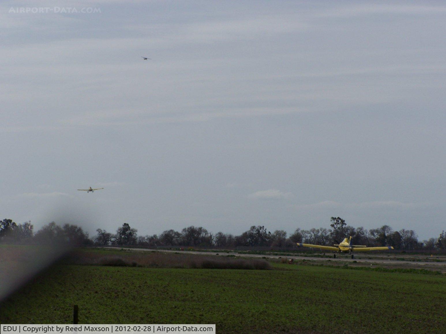 University Airport (EDU) - Looking south, a Cessna 152 and an Air Tractor departing from 17, an Air Tractor arriving.  As busy as KJFK, and no ATC!
