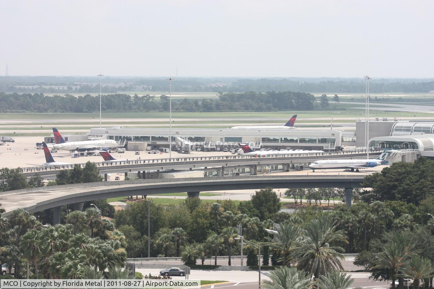 Orlando International Airport (MCO) - Delta and Air Tran planes around Airside 4, some at hardstands due to cancellations in the northeast from Hurricane Irene
