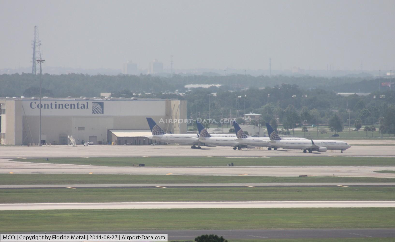 Orlando International Airport (MCO) - 4 Continental/United planes sitting at their hangar parked due to cancellations from Hurricane Irene