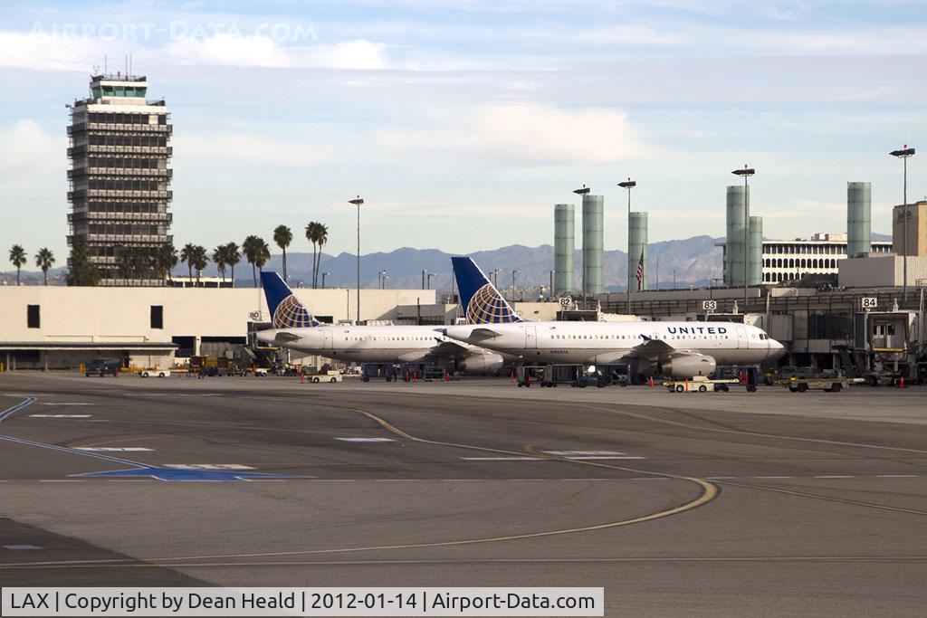Los Angeles International Airport (LAX) - A pair of United Airlines aircraft parked at Terminal 8. The control tower on the left was in use from October 1962 to April 1996.