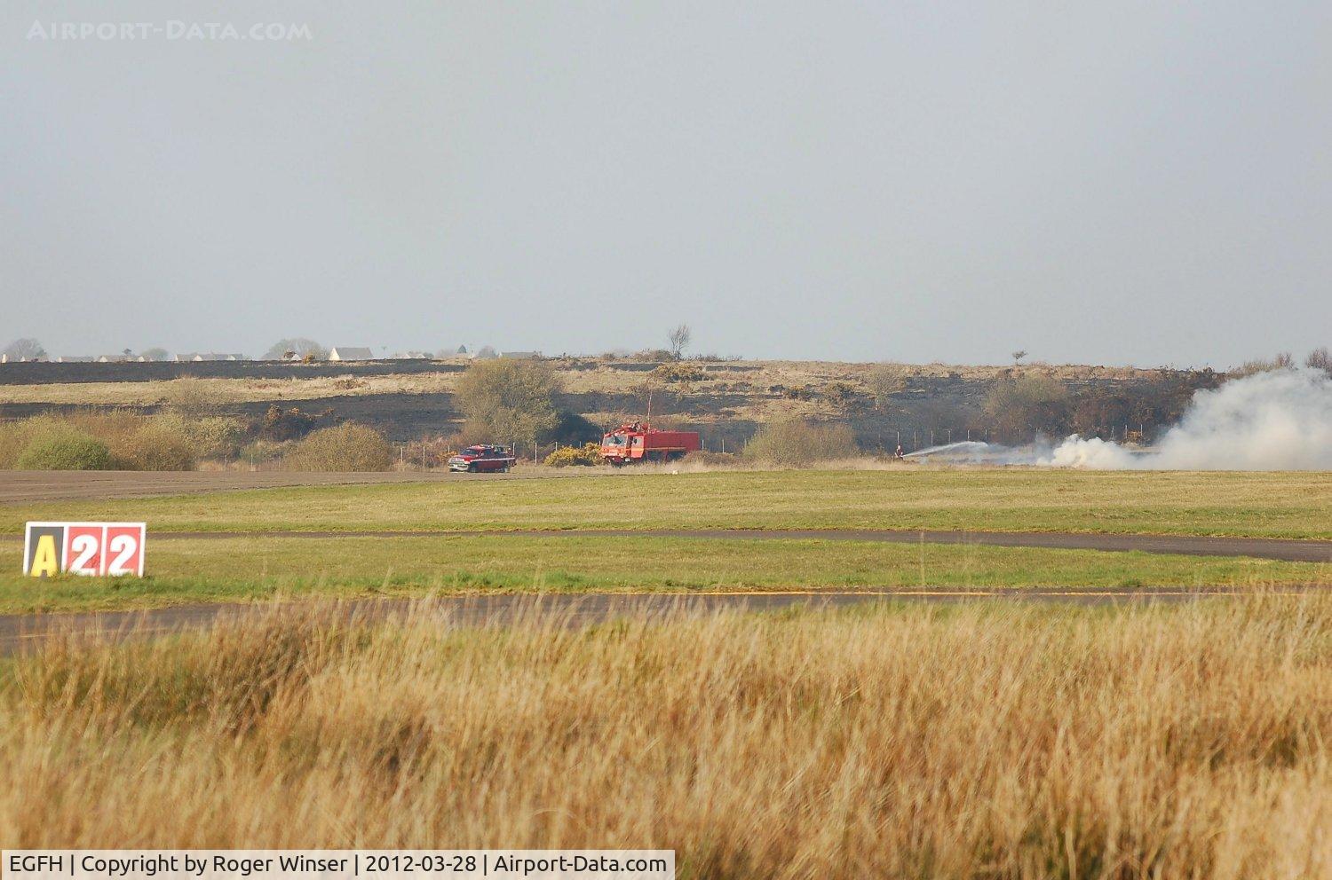 Swansea Airport, Swansea, Wales United Kingdom (EGFH) - Airport Fire and Rescue Services FIRE 1 and FIRE 2 tackle a blaze on the perimiter of the airfield.