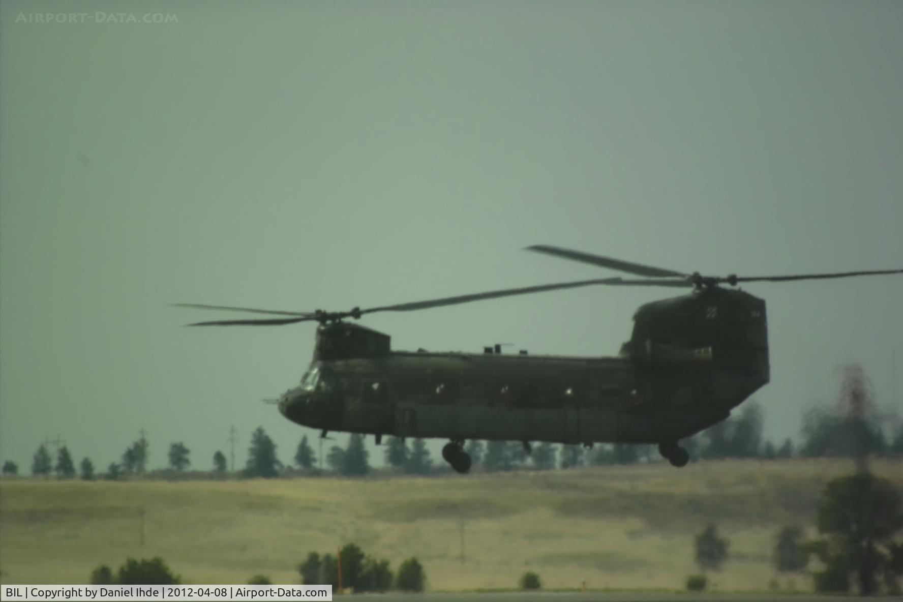 Billings Logan International Airport (BIL) - The chinook with number 124 hovering while another chinook taxi's to park @ KBIL.