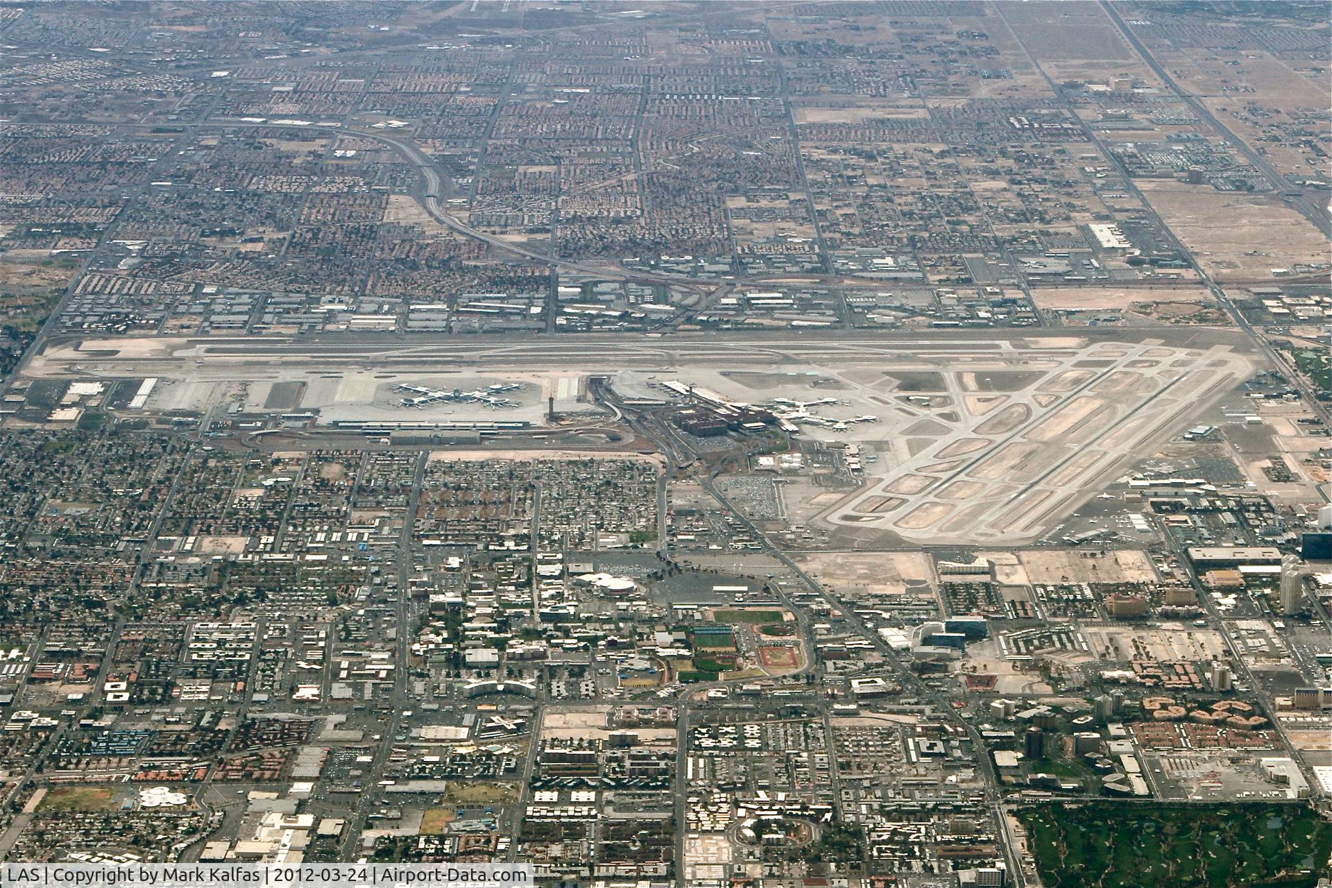 Harry Reid International Airport (LAS) - McCarran International/LAS, north of the airport, climbing through 12,000' heading 090 on the STAAV4 departure.
