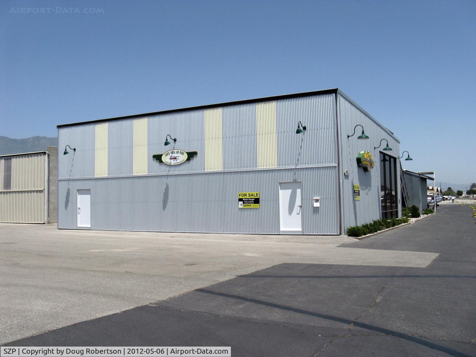 Santa Paula Airport (SZP) - Large deluxe newer hangar of Mysterious Legendary Fliers-In Our Own Mind-on Curtiss Taxi, with living quarters midfield location FOR SALE
