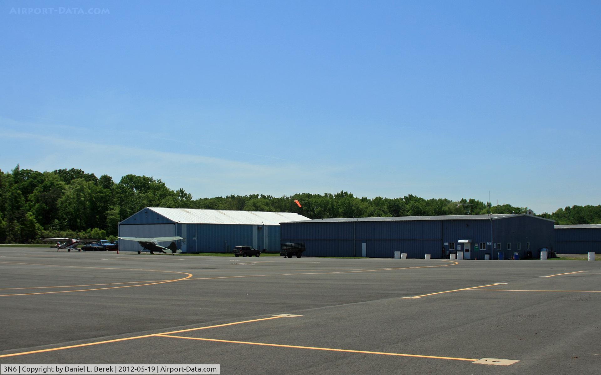Old Bridge Airport (3N6) - This is the north end of the airport, with the main runway in the background.  There is ample covered storage space for small aircraft.