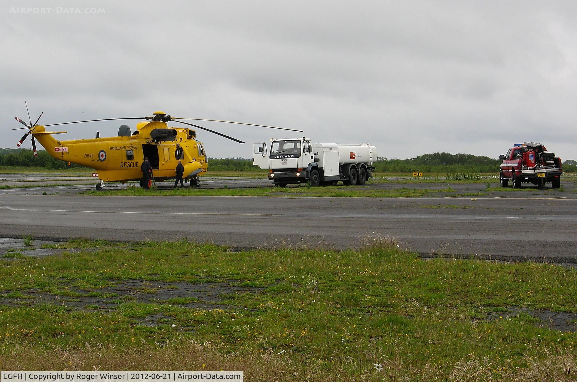 Swansea Airport, Swansea, Wales United Kingdom (EGFH) - RAF SAR Sea King taking on fuel with Fire and Rescue tender (FIRE 2) in attendence.