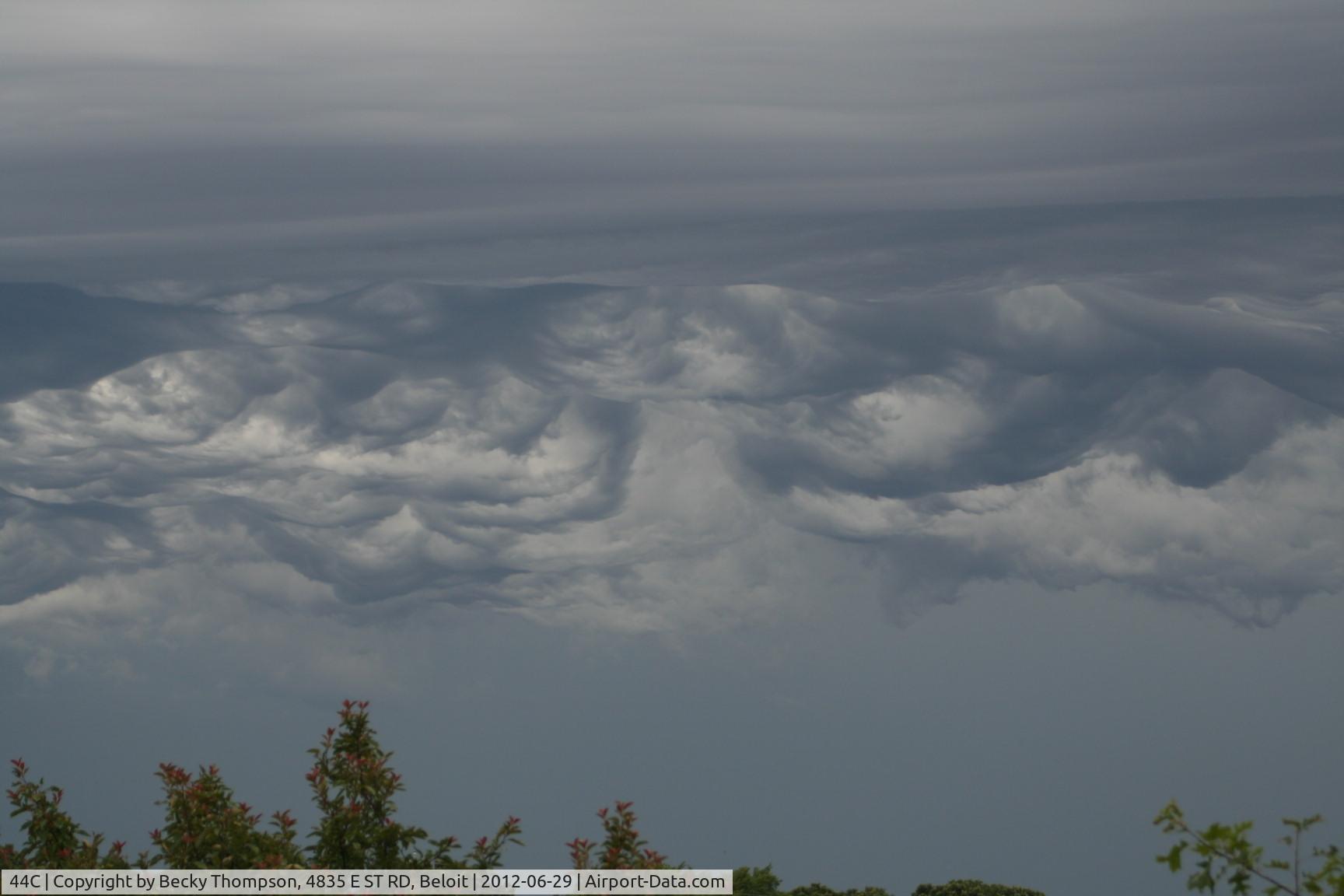 Beloit Airport (44C) - Unusual clouds today.  I took this photo from my driveway, 1/4 mi. E on Hwy 67 of parachuters coming down with weird clouds in background. 