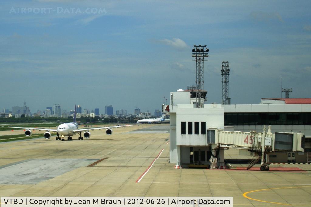 Don Muang International Airport (Old Bangkok International Airport), Bangkok Thailand (VTBD) - Due to congestion of BKK airport, several airlines will set up again their hub at DMK. Bangkok skyline in background of photo.