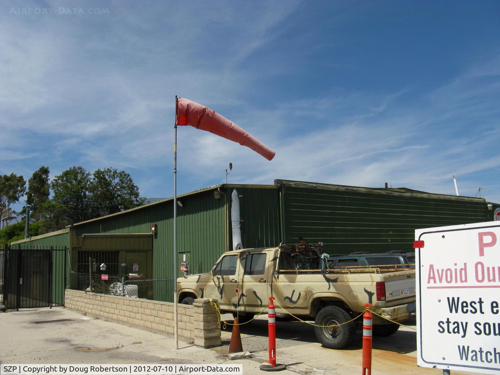 Santa Paula Airport (SZP) - Rwy 22 Windsock in a strong wind with gusts forcing some landing go-arounds on Rwy 22. The green hangar behind is one of the ex-Steve McQueen hangars at SZP where he once lived and learned to fly. Pete Mason was his CFI.