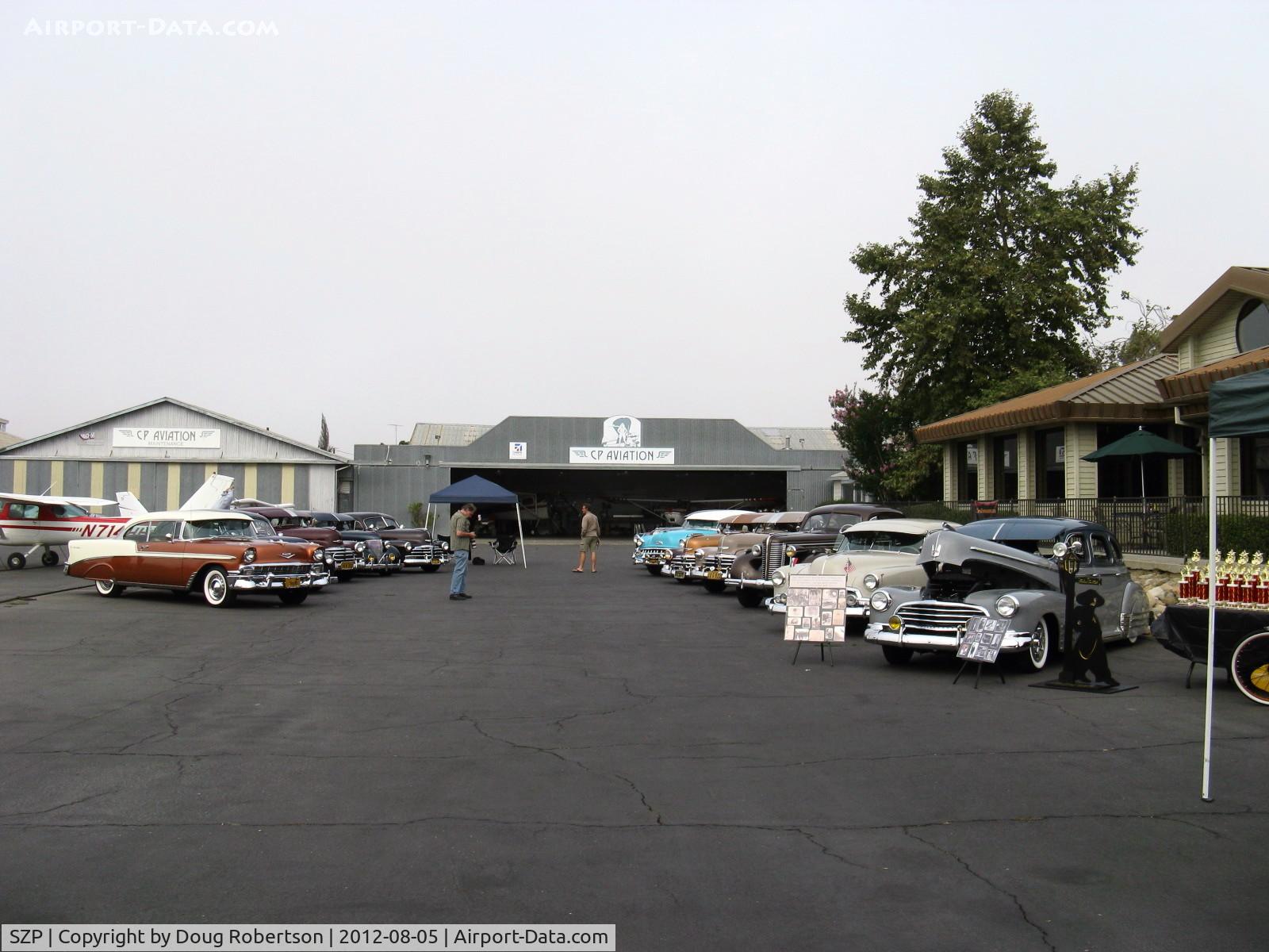 Santa Paula Airport (SZP) - First Sunday Aviation Museum of Santa Paula Open House & Fly-In invites car clubs-early morning arrivals-later four hangar rows blocked by old cars