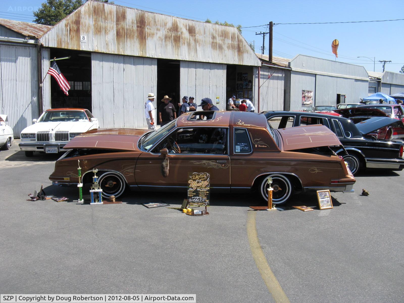 Santa Paula Airport (SZP) - First Sunday Aviation Museum Open House & Fly-In invites car clubs-this is a 1982 Oldsmobile Cutlass Supreme club coupe extensively customized. Tilted for viewing.